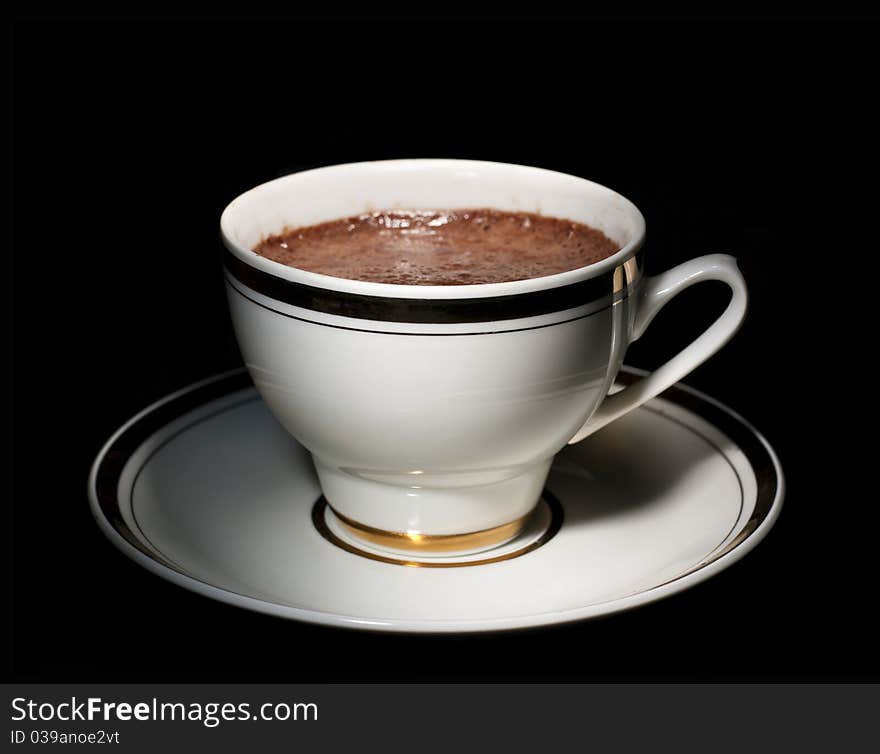 A white cup of how chocolate drink, on black background. A white cup of how chocolate drink, on black background