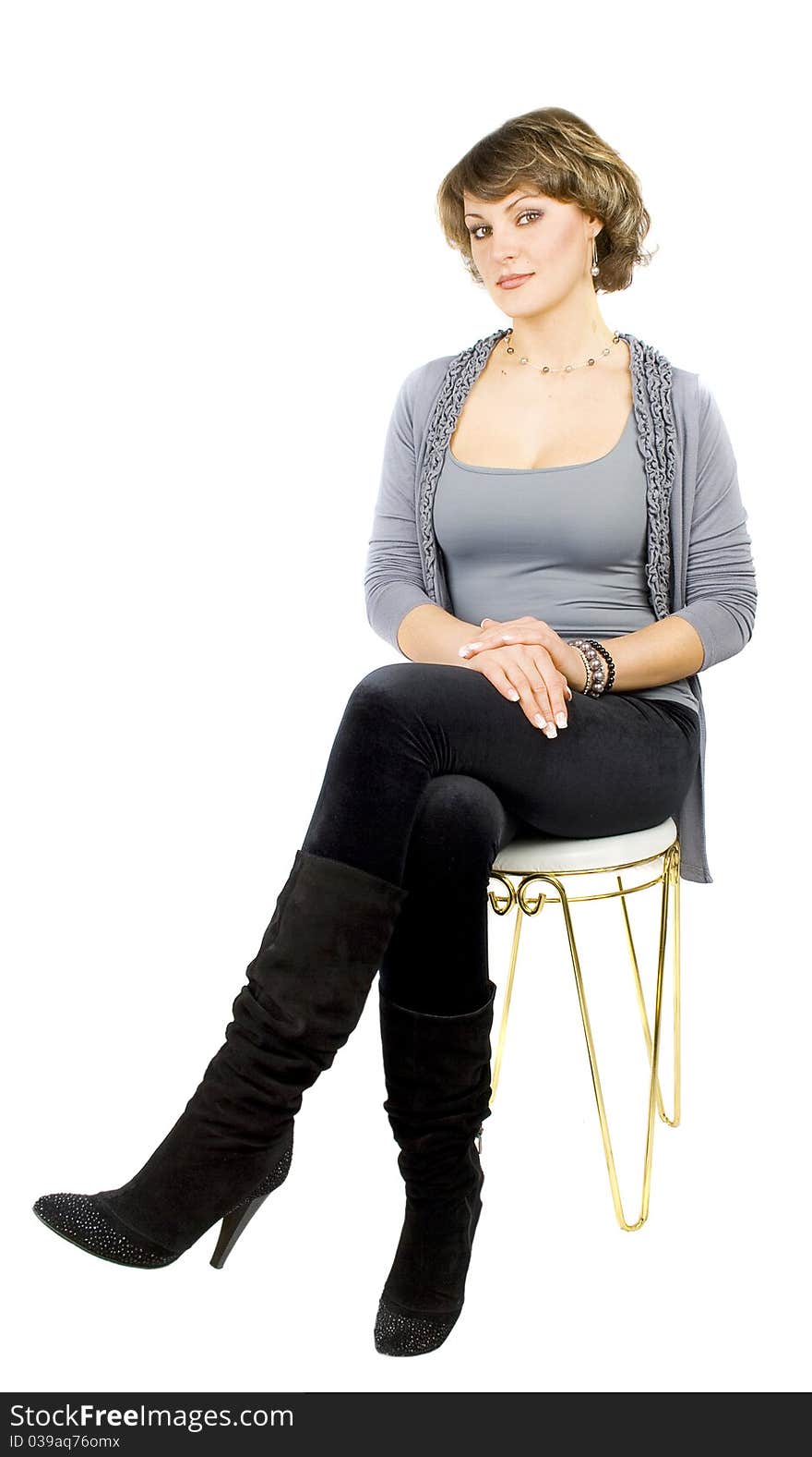 Girl sitting on the bar chair at white background