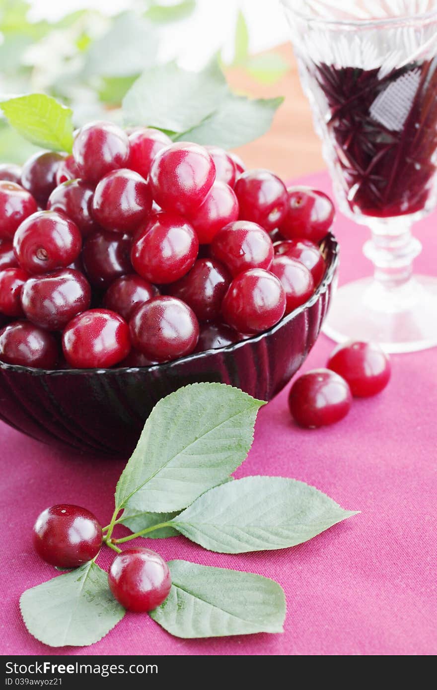 Fresh cherries in the plate and the wine