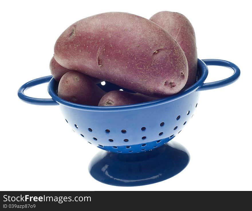 Whole Baby Red Potato in Blue Colander Isolated on White with a Clipping Path.