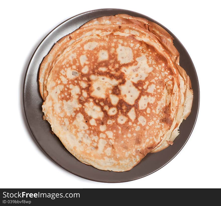 Fresh pancakes on a brown plate on the white background