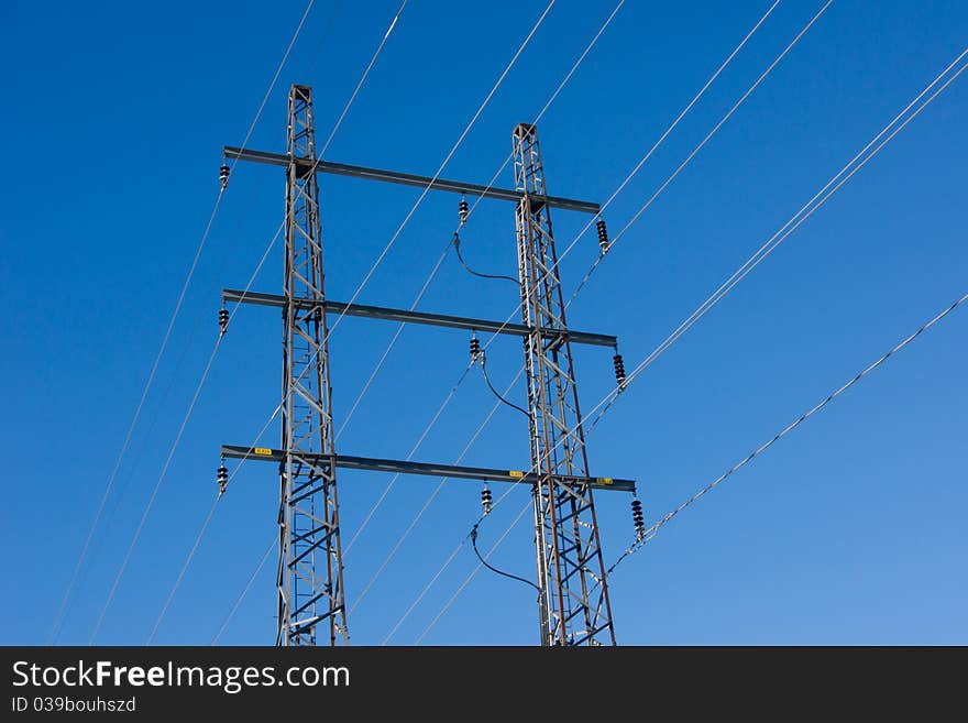 Power wire pylon against clear blue sky. Power wire pylon against clear blue sky.