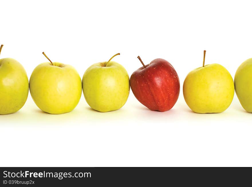 Line of green apples and one red apple. Line of green apples and one red apple