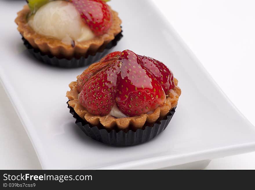 Assorted flavor fruits tart served on plate. Assorted flavor fruits tart served on plate