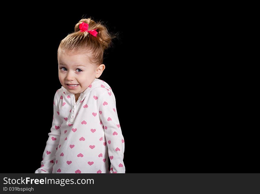 A cute kid with a funny facial expression and a cute pose! She is wearing a heart T shirt. A cute kid with a funny facial expression and a cute pose! She is wearing a heart T shirt.