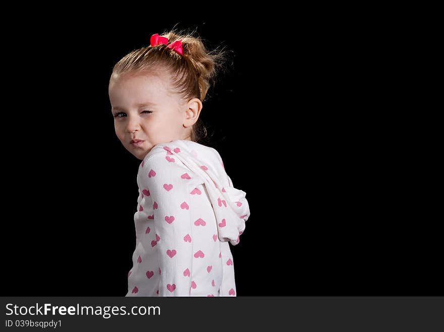 A cute kid with a funny facial expression and a cute pose! She is wearing a heart T shirt. A cute kid with a funny facial expression and a cute pose! She is wearing a heart T shirt.