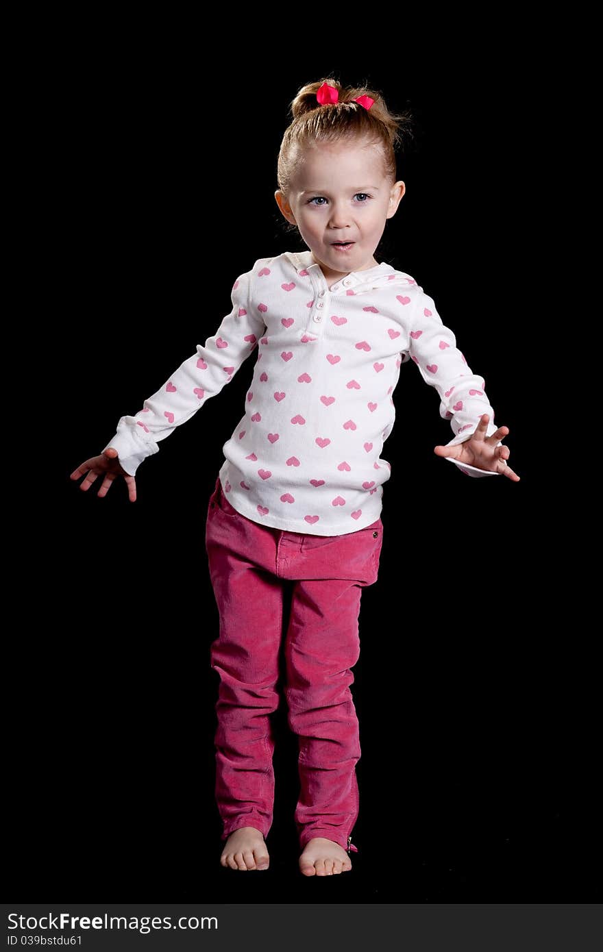 A cute kid with a funny facial expression and a cute pose!  She is wearing a heart T shirt. A cute kid with a funny facial expression and a cute pose!  She is wearing a heart T shirt.