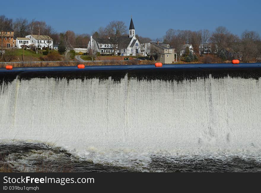 The Dam in Pittsfield NH, The lake is behind the Orange barrier with a view of some shore line behind the Dam. The Dam in Pittsfield NH, The lake is behind the Orange barrier with a view of some shore line behind the Dam.