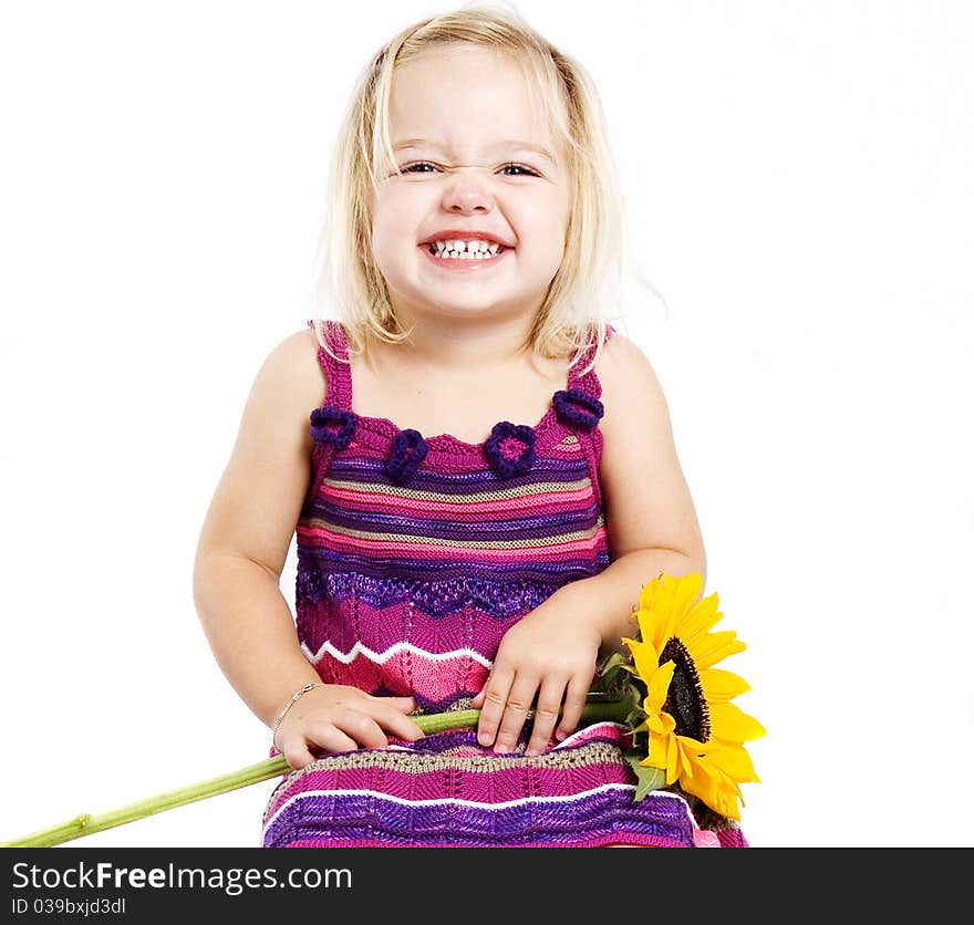 Young pretty blond girl happy and smiling with a sunflower. Young pretty blond girl happy and smiling with a sunflower