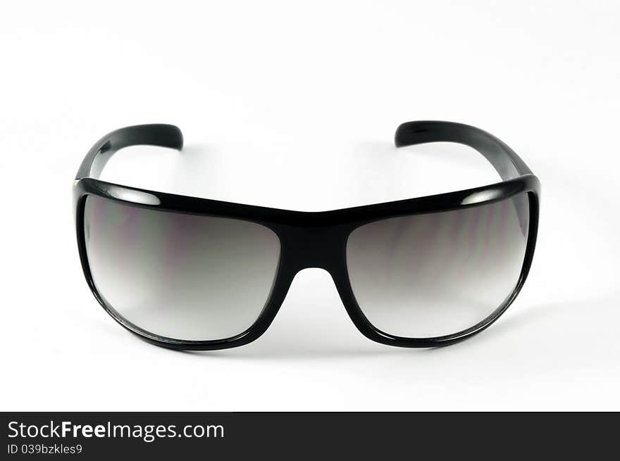 Modern sunglasses on white surface