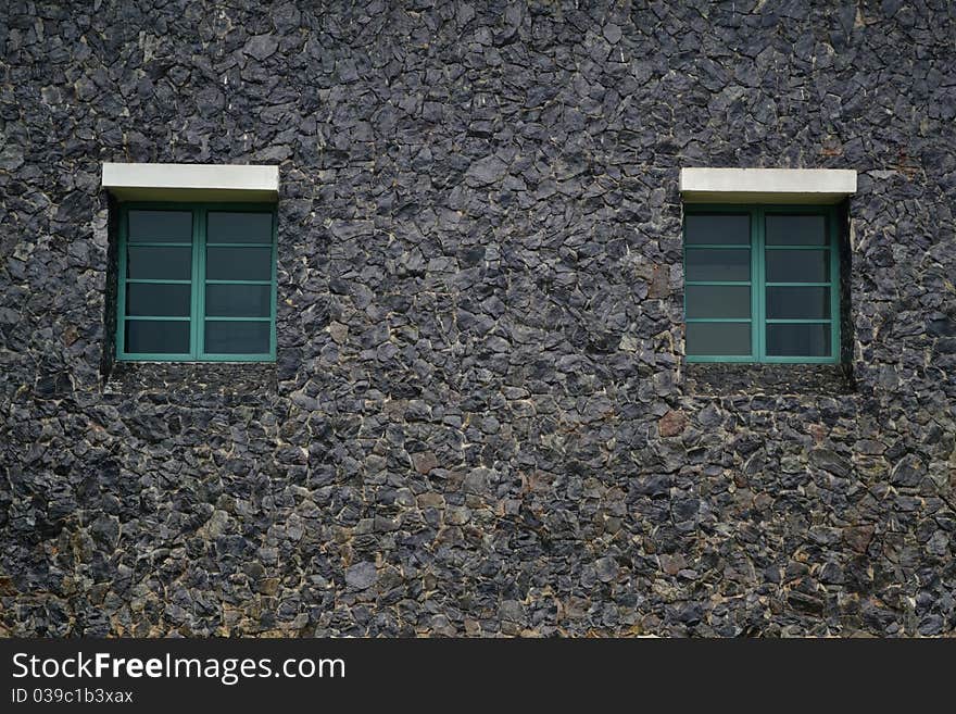 Shuttered green window on painted brick black wall. Shuttered green window on painted brick black wall