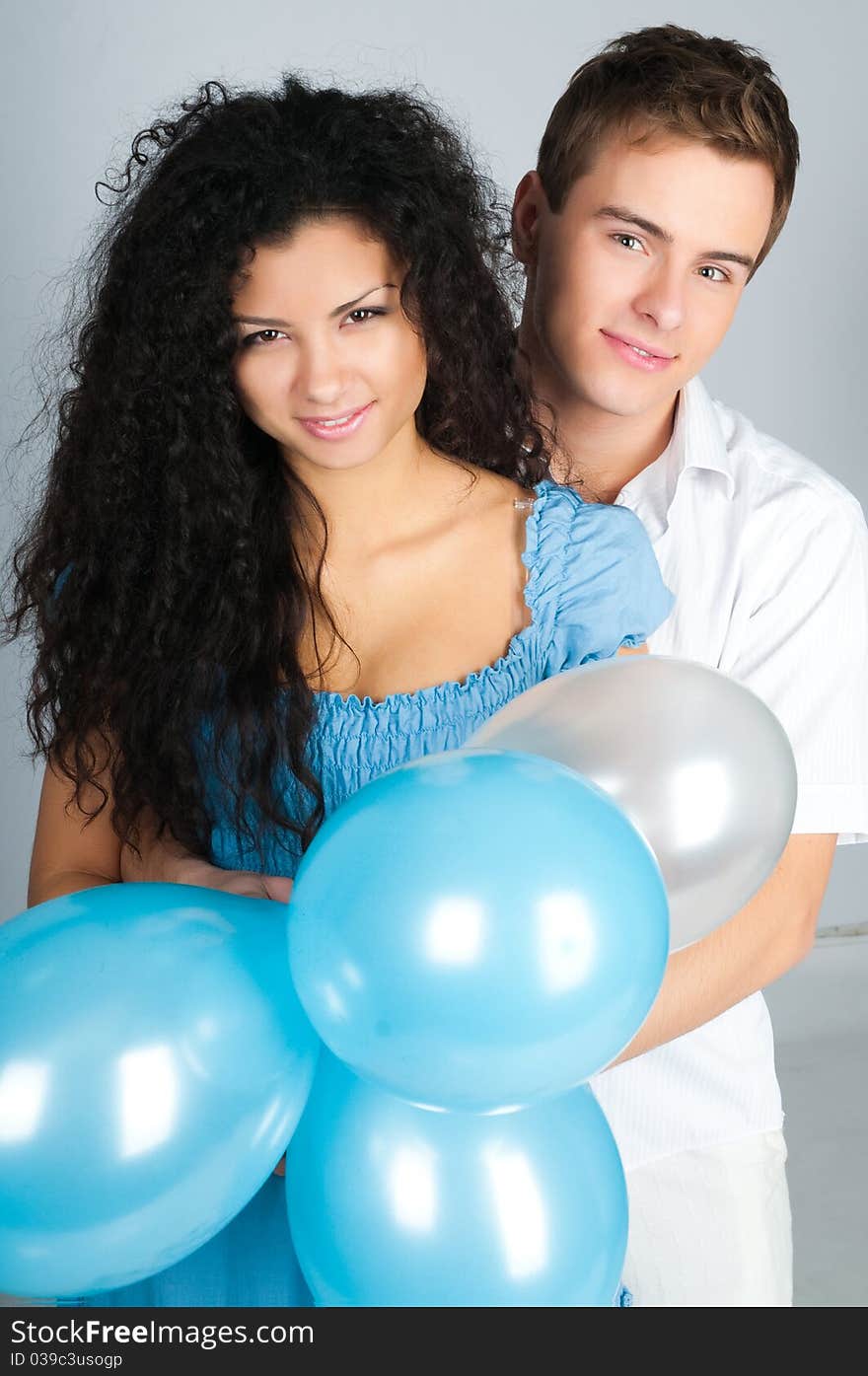 Beautiful young couple with balloons