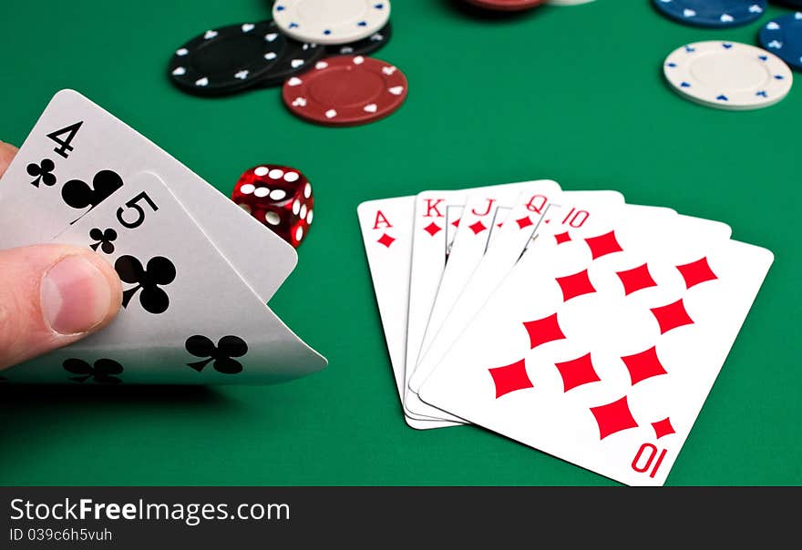 Playing cards and chips on a green background