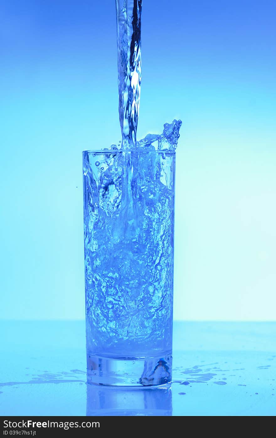 A jet of pure water is poured into a glass and forms a spray. A jet of pure water is poured into a glass and forms a spray