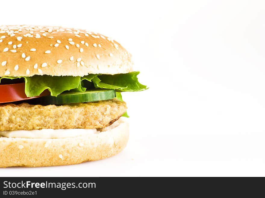 Chicken burger with tomato cucumber lettuce and mayonnaise over white