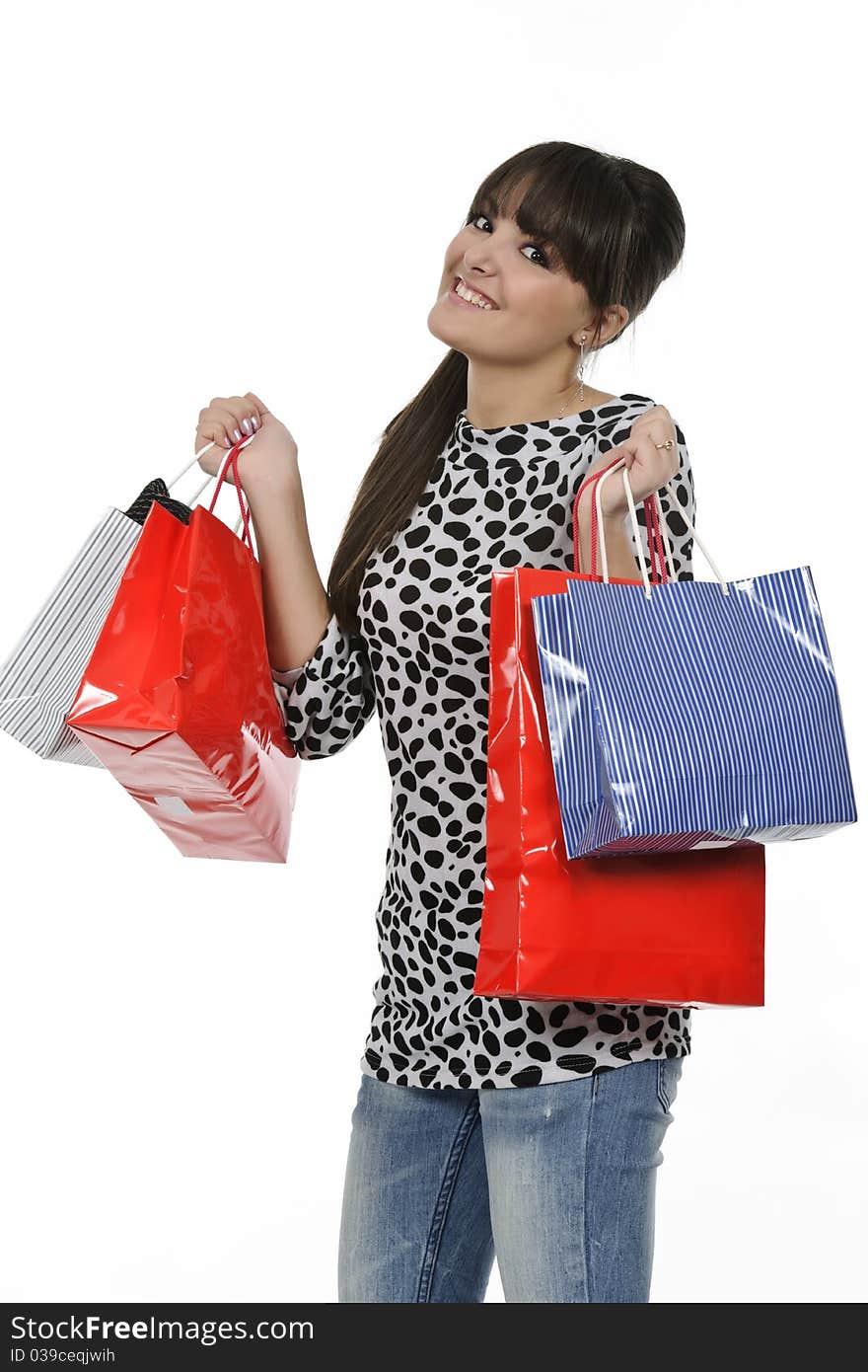 Young woman shopping with gift bags in hand. Young woman shopping with gift bags in hand