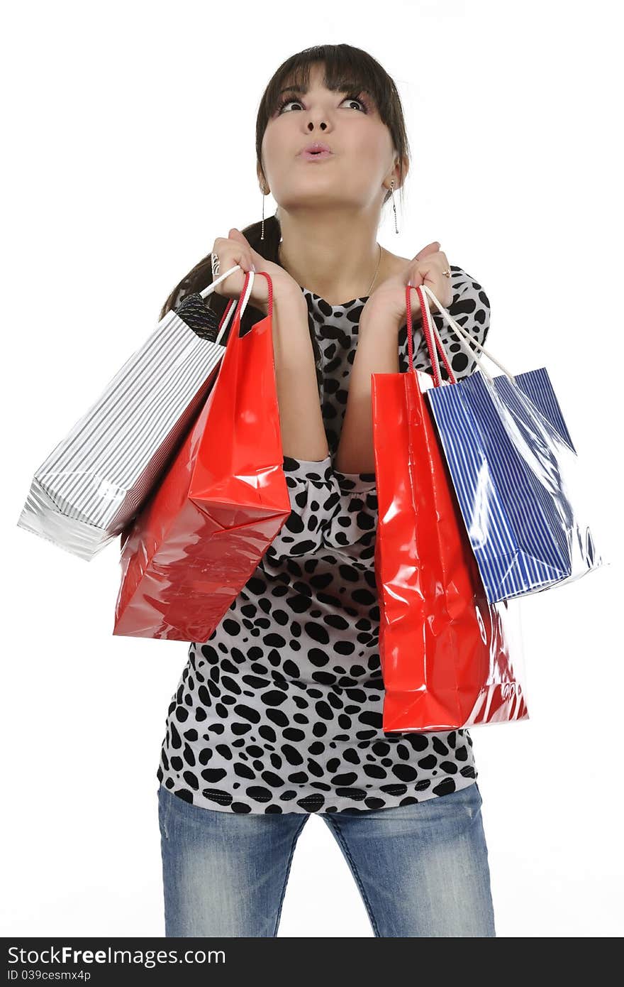 Young woman shopping with gift bags in hand. Young woman shopping with gift bags in hand