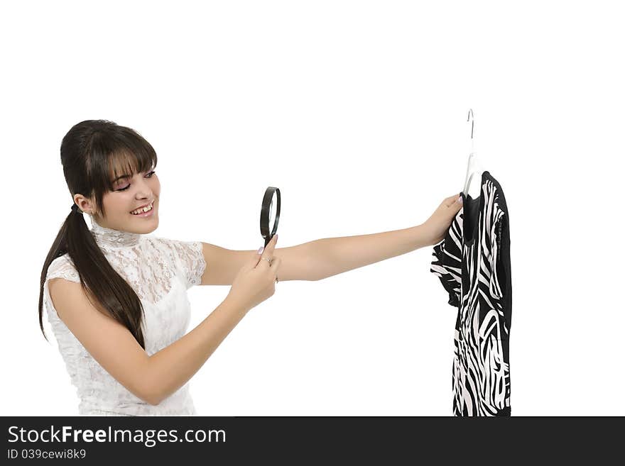 Young woman is holding a hanger with a T-shirt. Young woman is holding a hanger with a T-shirt