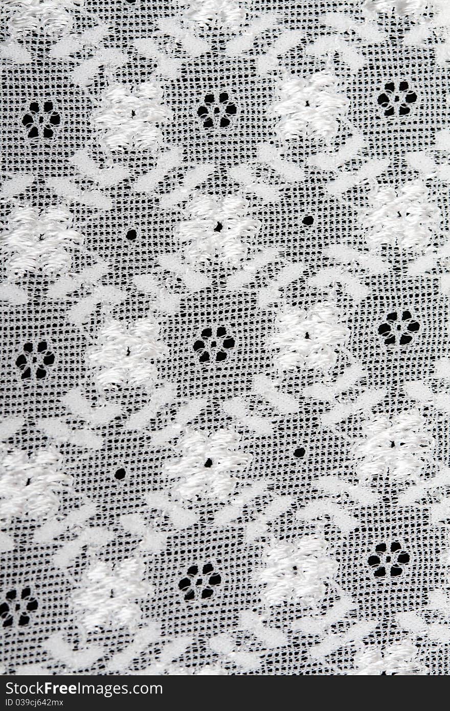 Background of white lace with embroidered designs