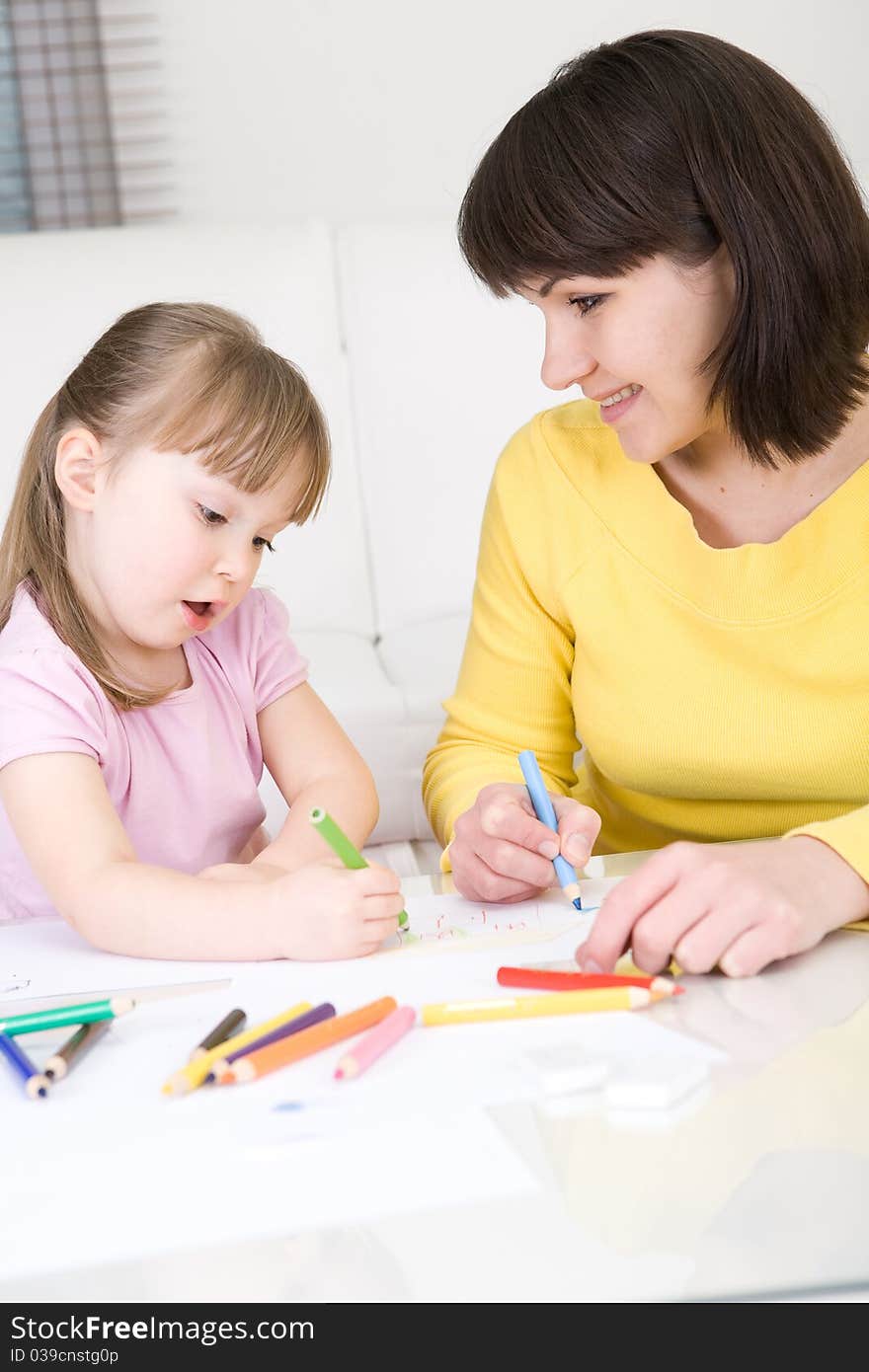 Mother and daughter having fun in kindergarden