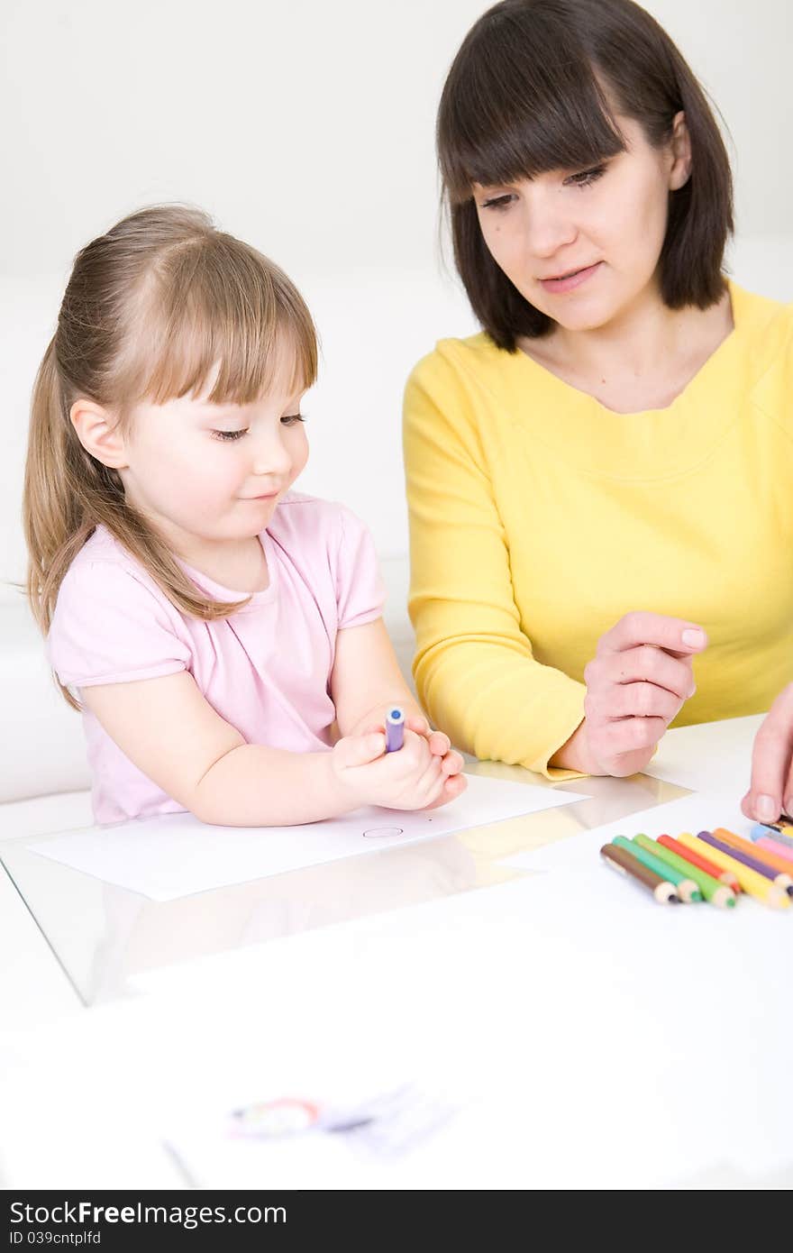 Mother and daughter having fun in kindergarden