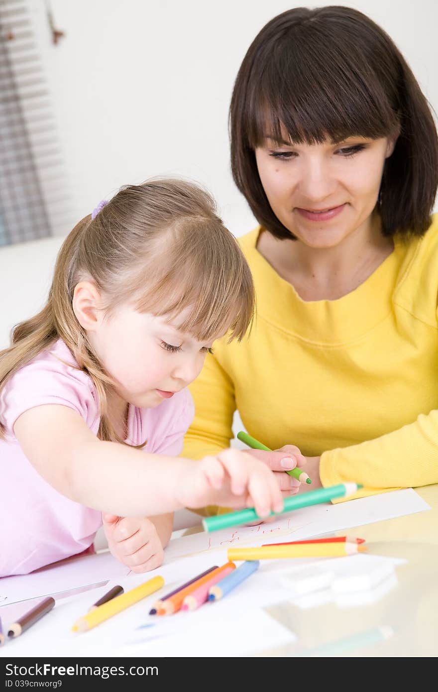 Mother and daughter having fun in kindergarden