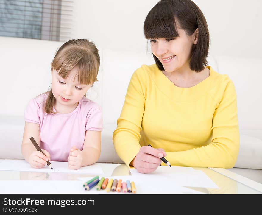 Mother and daughter having fun in kindergarden