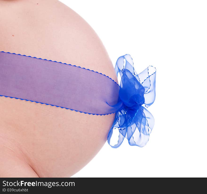 Abdomen of a pregnant girl with a blue ribbon isolated on white. Abdomen of a pregnant girl with a blue ribbon isolated on white