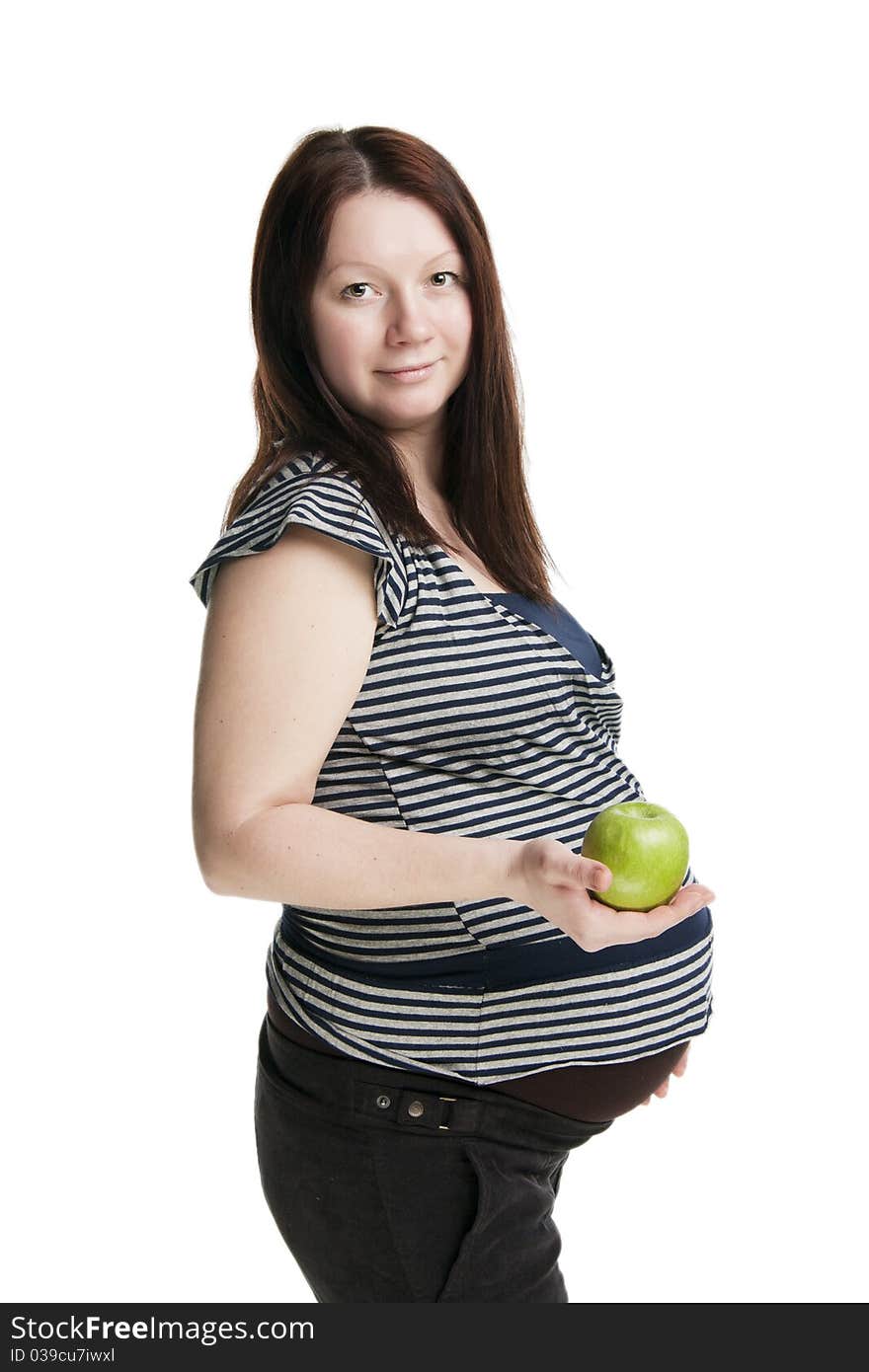 Beautiful pregnant woman holding green apple, isolated on white