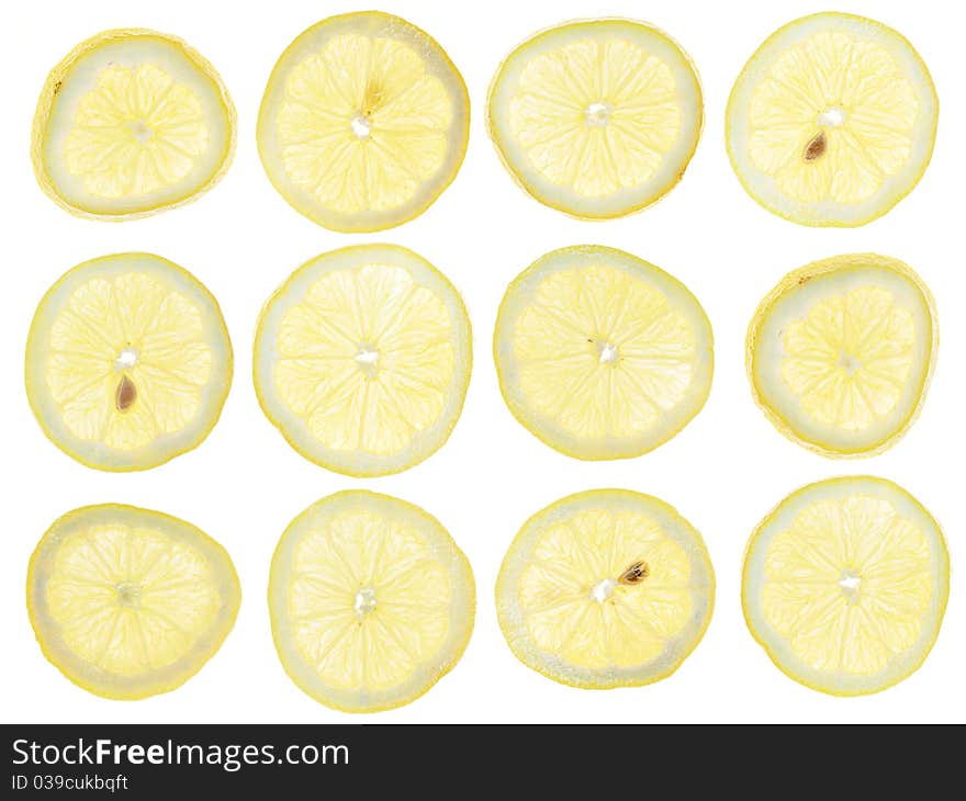 Twelve lemon slices on white background. Twelve lemon slices on white background.