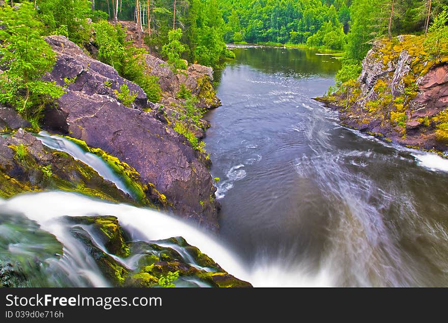 Forest lake and small waterfall