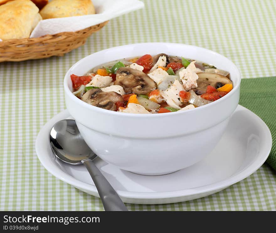 Chicken vegetable soup with mushrooms in a bowl