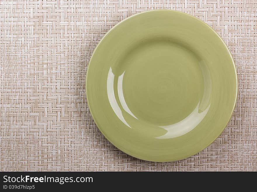 Round ceramic dish on a background mat for the second course. Round ceramic dish on a background mat for the second course.