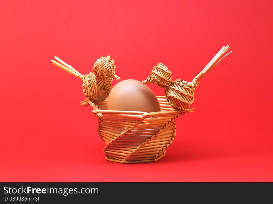 Two straw birds with egg