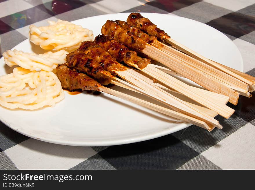 A delicious traditional Balinese seafood skewers with crackers. A delicious traditional Balinese seafood skewers with crackers.