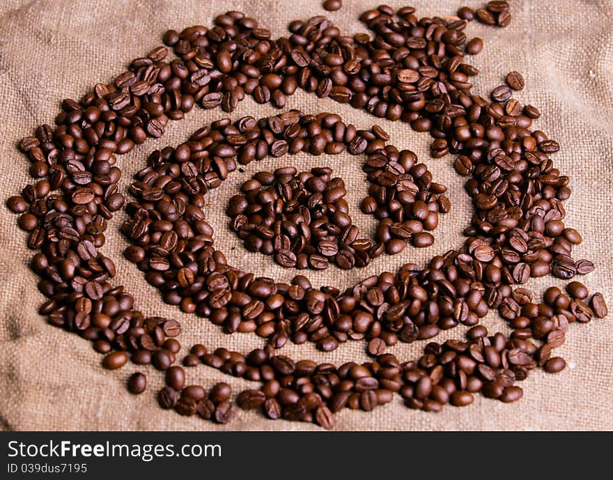 Grains of black coffee on a fabric.