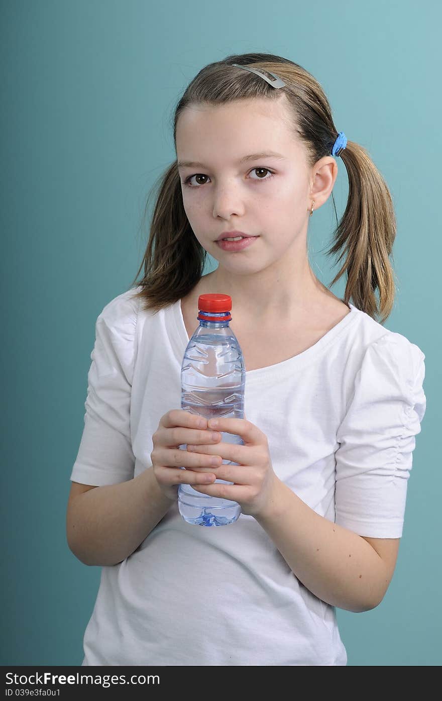 Active healhty schoolgirl relaxing with fresh water after exercises. Active healhty schoolgirl relaxing with fresh water after exercises