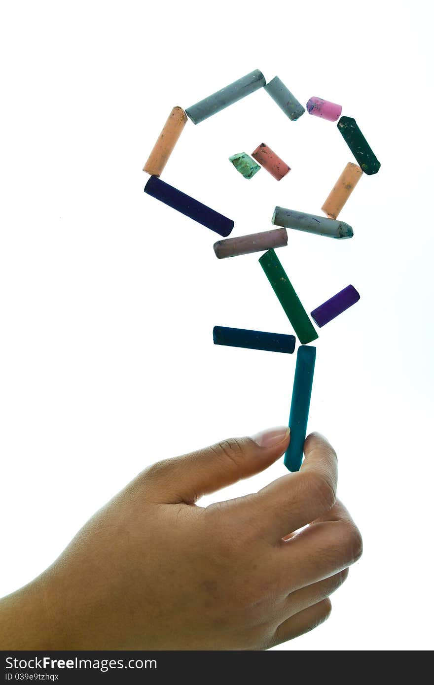 Hand that give a flower set by pastel sticks. Hand that give a flower set by pastel sticks