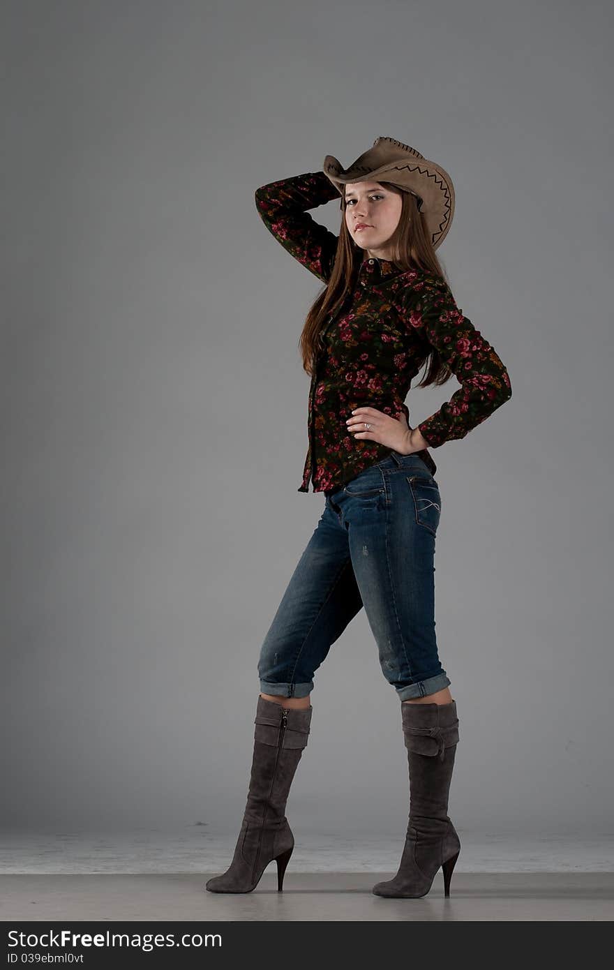 Attractive cowgirl portrait on white background