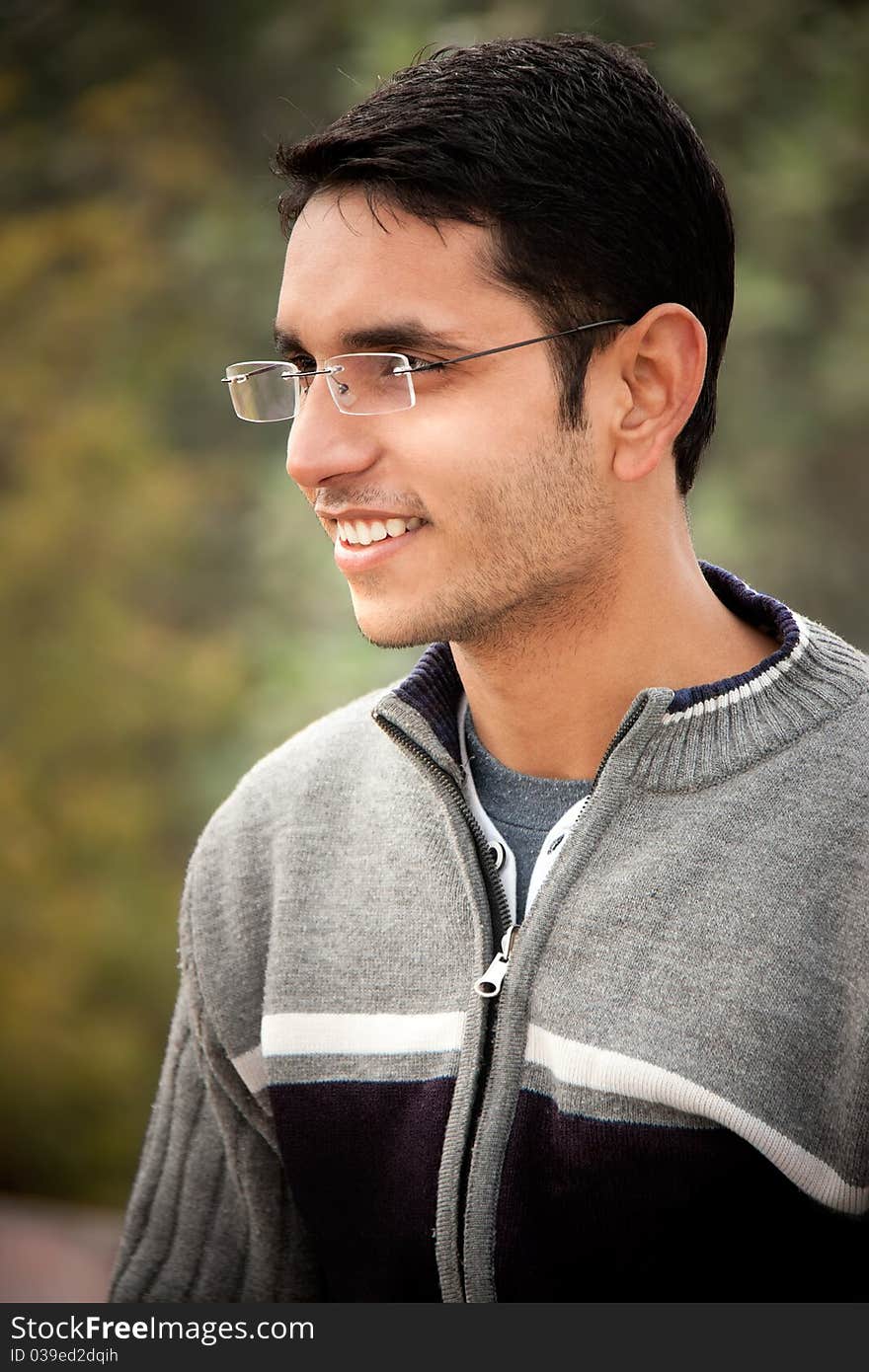 Close up of handsome Indian man over natural background