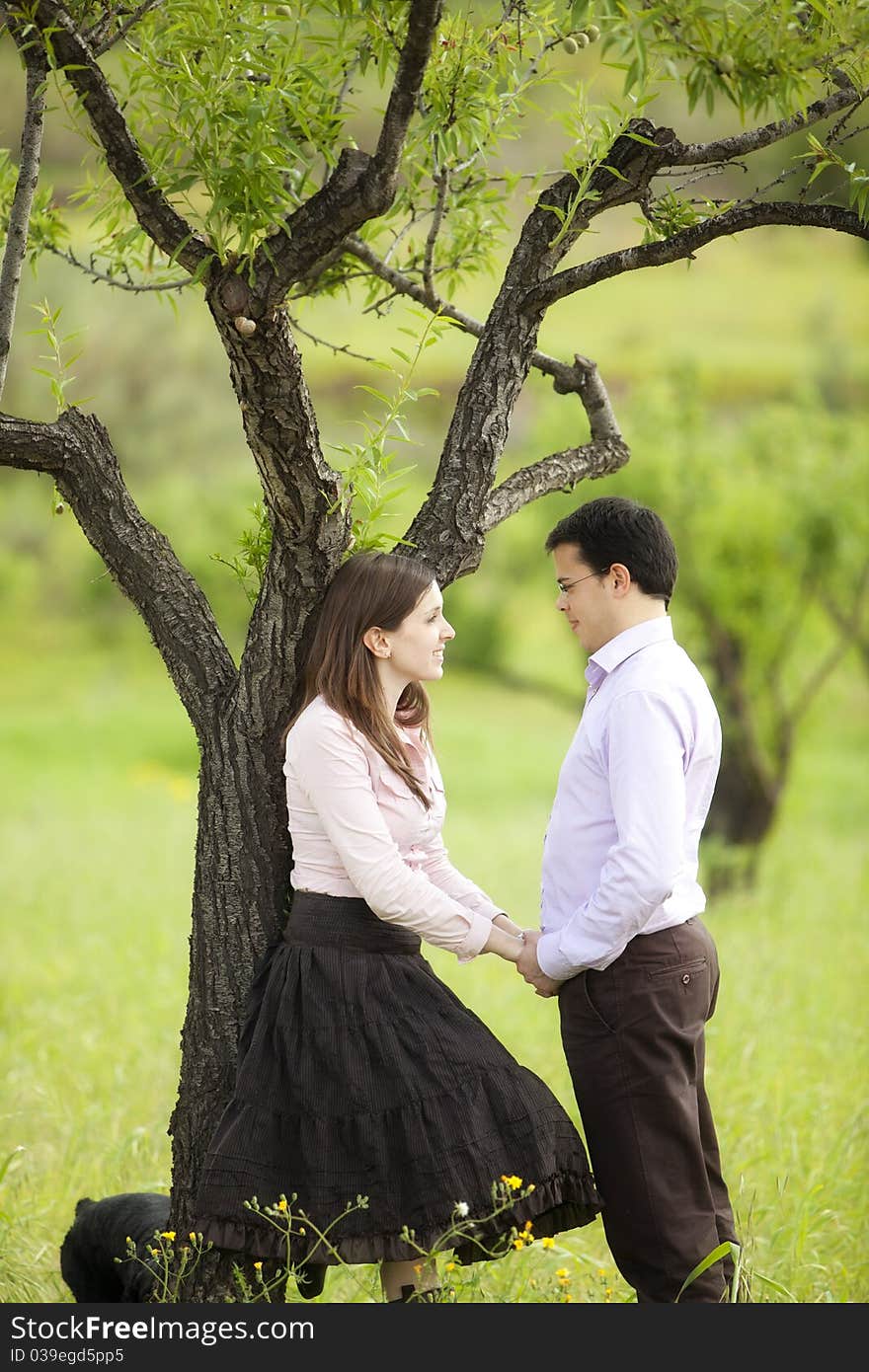 Young lovely couple staring each other in nature. Young lovely couple staring each other in nature.