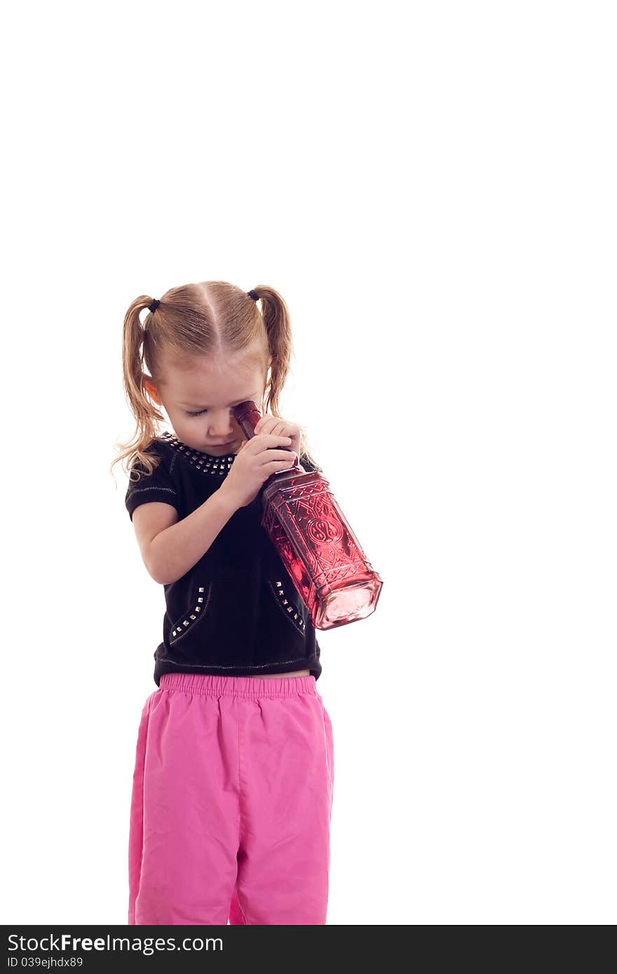 A cute girl looking down through a glass bottle. The image is isolated. A cute girl looking down through a glass bottle. The image is isolated.