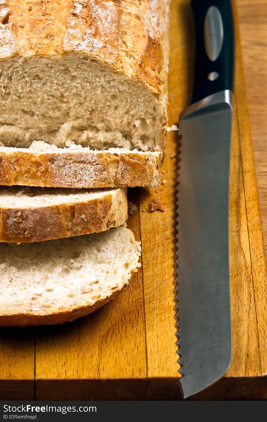 White Bread And Knife On Wooden Cutting Board