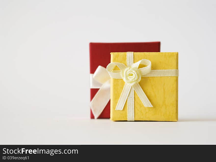 The photography of two presents with bow on the white surface. The photography of two presents with bow on the white surface.