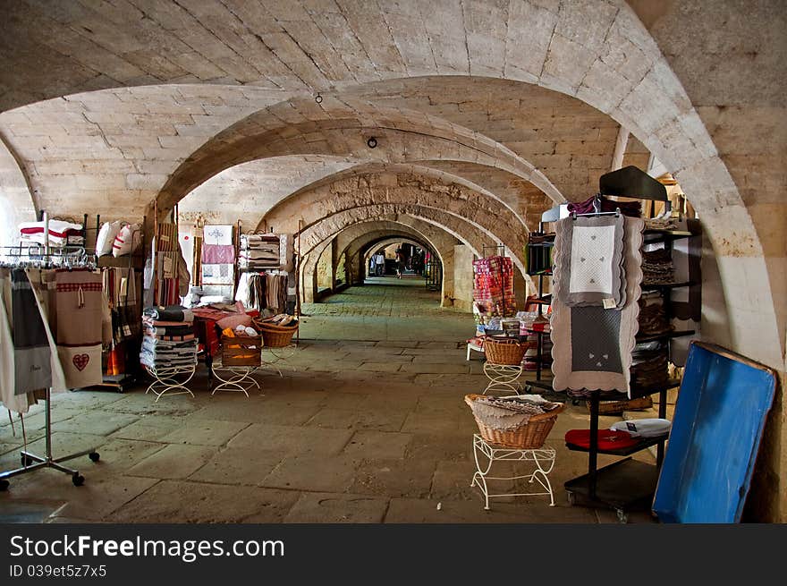 An ancient arcade is used for display goods on the counter