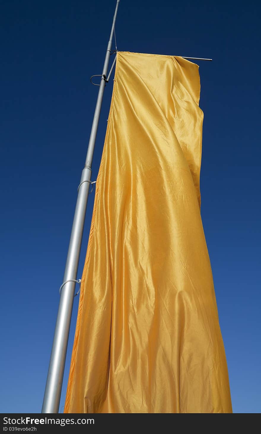 The flag is flapping in the wind. The flag is flapping in the wind