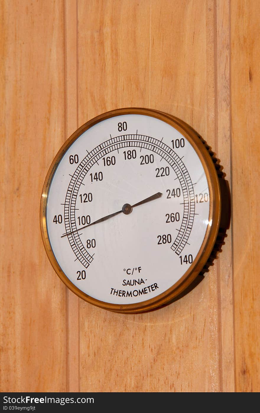 Sauna thermometer display with wooden background