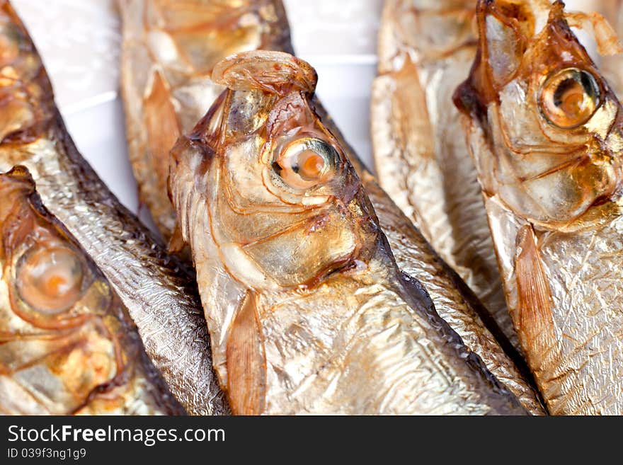 Golden smoke-dried fish on white