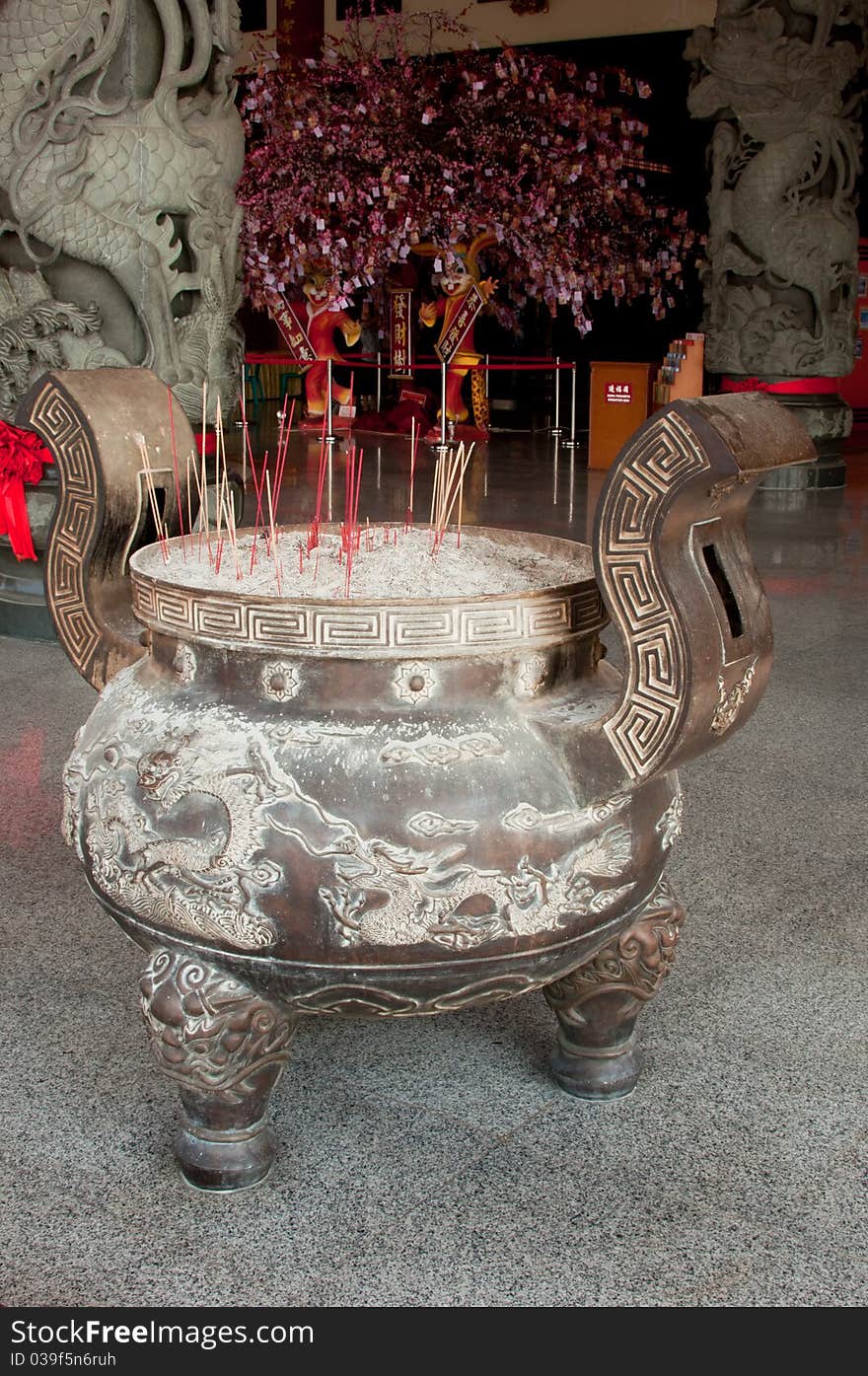 Incense burning in front of a Buddhist temple. Incense burning in front of a Buddhist temple