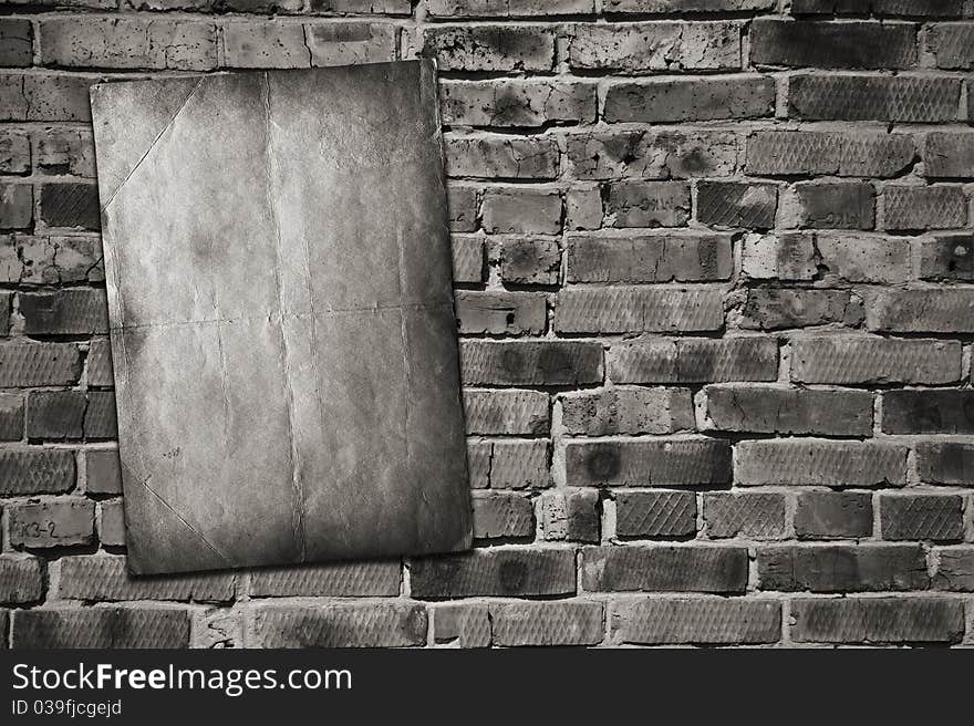 Old paper on brick wall. Old paper on brick wall